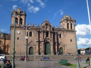beige stone cathedral with green doors